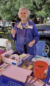 Artist at work at fair creating watercolors