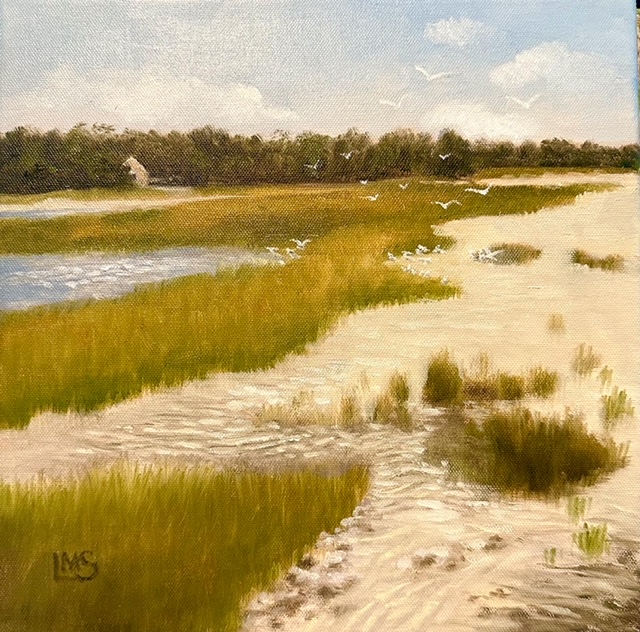 Beach and grasses with water and seagulls squabbling